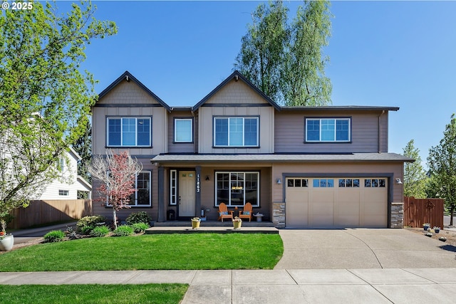 11862 White Ln, Oregon City, OR 97045 - view of front facade with covered porch, concrete driveway, a garage, and stone siding