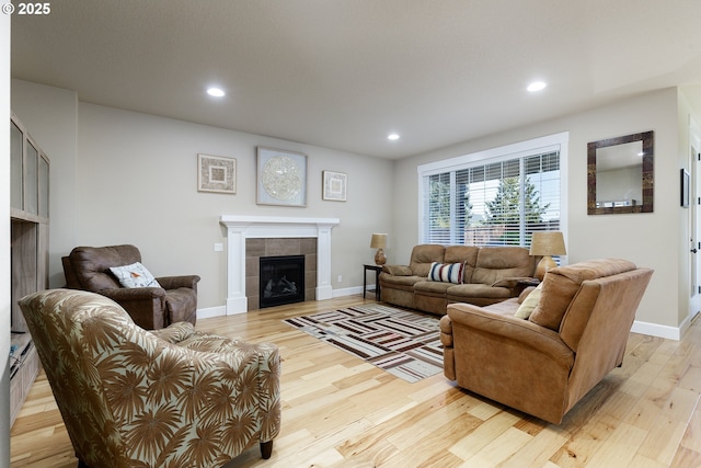 11862 White Ln, Oregon City, OR 97045 - living room featuring a tiled fireplace, light wood-type flooring, recessed lighting, and baseboards