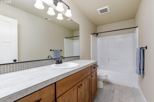 11862 White Ln, Oregon City, OR 97045 - bathroom featuring vanity, toilet, wood finished floors, shower / bath combination, and tasteful backsplash