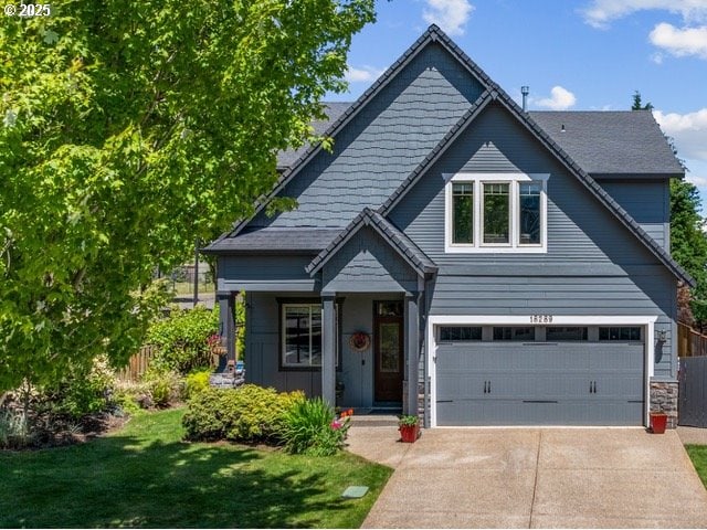 18289 SW Maidenfern Ln, Sherwood, OR 97140 - view of front of property with concrete driveway, a garage, stone siding, and covered porch