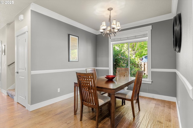 18289 SW Maidenfern Ln, Sherwood, OR 97140 - dining area featuring a chandelier, light wood finished floors, ornamental molding, and baseboards
