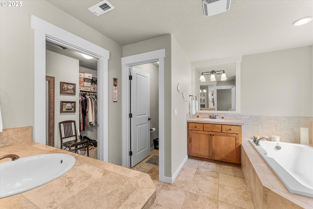 18289 SW Maidenfern Ln, Sherwood, OR 97140 - bathroom featuring two vanities, a bath, and a spacious closet