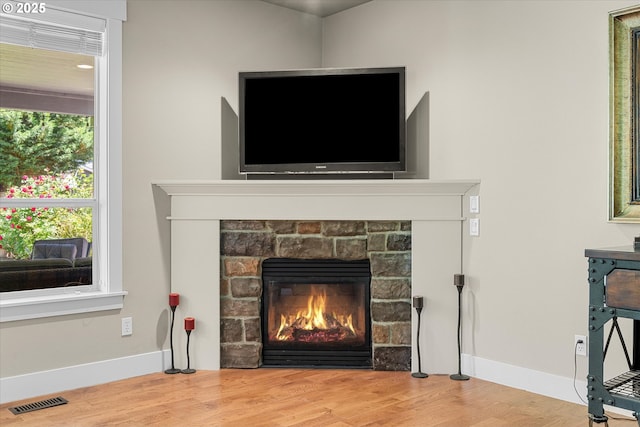 18289 SW Maidenfern Ln, Sherwood, OR 97140 - detailed view of baseboards, wood finished floors, and a fireplace