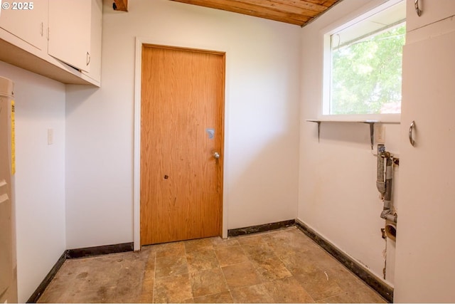 washroom with baseboards, stone finish flooring, and wood ceiling