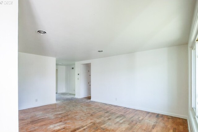 unfurnished room featuring light wood-style flooring and baseboards