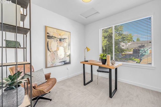 office space featuring attic access, baseboards, and light carpet