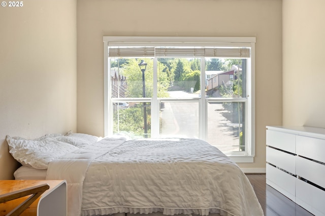 8996 SE Chloe Ln, Happy Valley, OR 97086 - bedroom with multiple windows, wood finished floors, and baseboards
