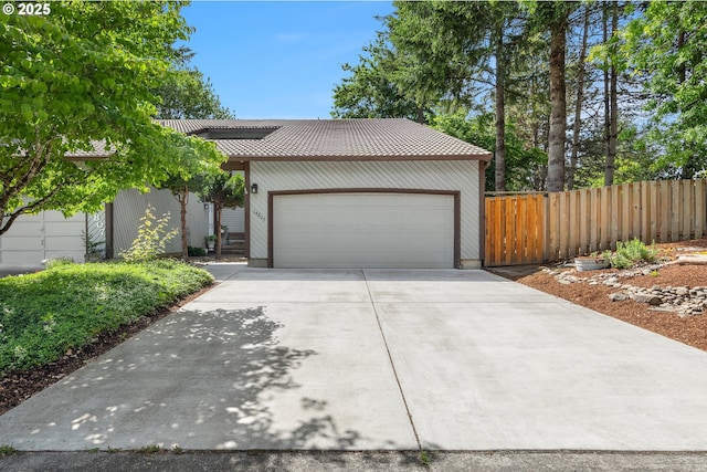 14805 SW 109th Ave, Portland, OR 97224 - view of front facade with driveway and a garage