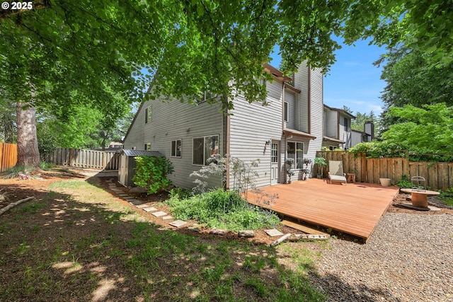 14805 SW 109th Ave, Portland, OR 97224 - back of house with a fenced backyard, a deck, and a chimney