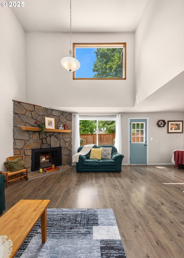 14805 SW 109th Ave, Portland, OR 97224 - living area featuring a high ceiling, a fireplace, and wood finished floors