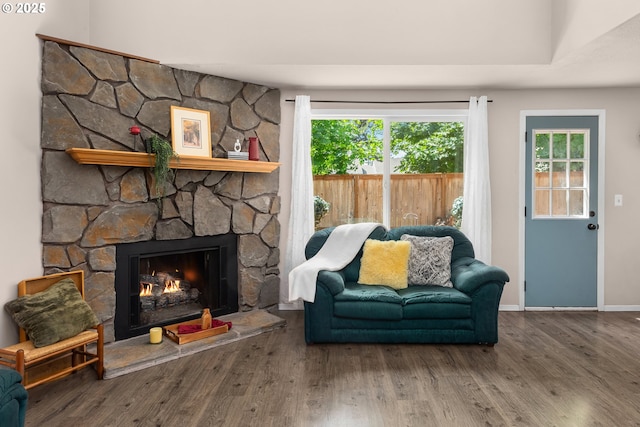 14805 SW 109th Ave, Portland, OR 97224 - living area featuring a stone fireplace, wood finished floors, and healthy amount of natural light