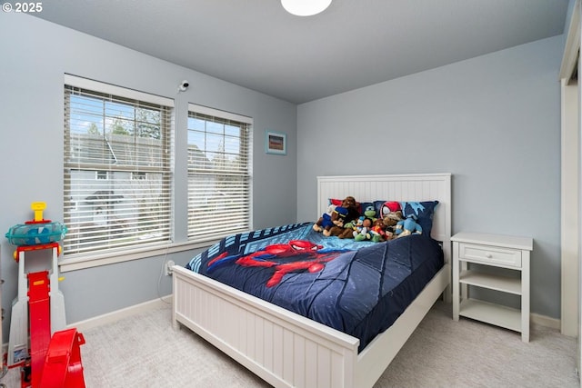 bedroom with baseboards and carpet floors