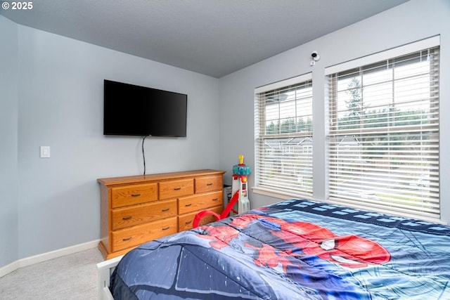 carpeted bedroom featuring baseboards