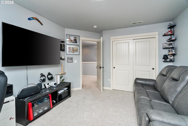 living room featuring visible vents, baseboards, and carpet