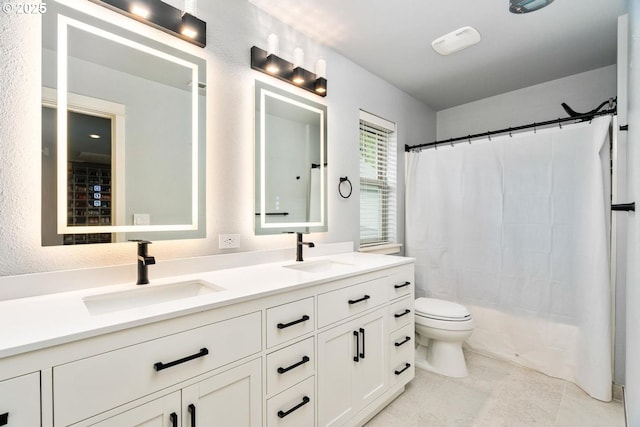 full bath with a sink, a shower with shower curtain, and double vanity