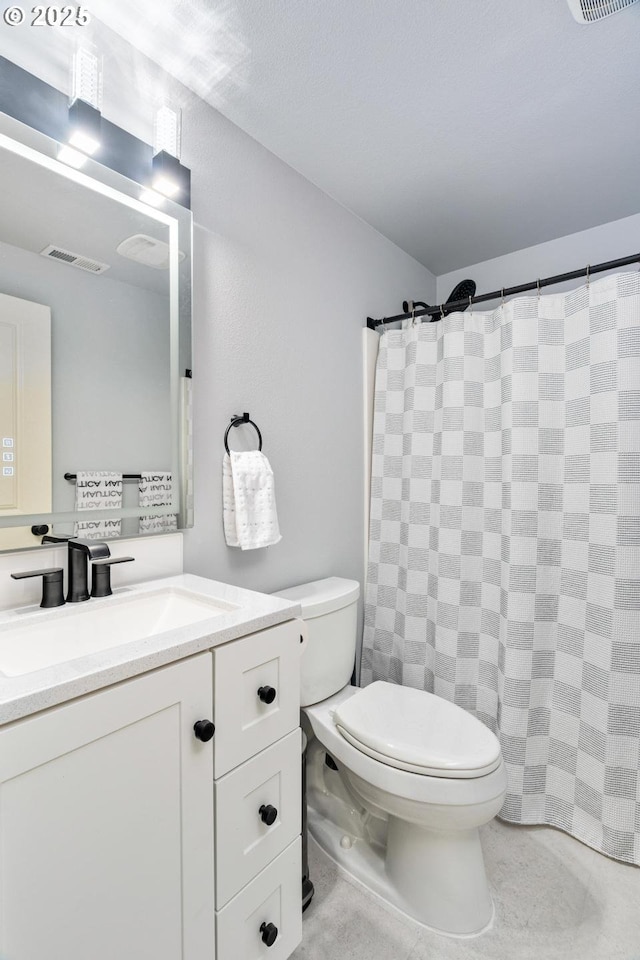 bathroom featuring vanity, toilet, a shower with curtain, and visible vents