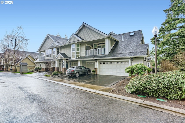 view of front of property featuring a residential view, roof with shingles, driveway, and a balcony