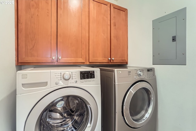 laundry area featuring cabinet space, electric panel, and separate washer and dryer