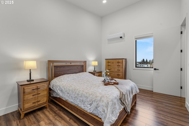 bedroom featuring dark hardwood / wood-style floors and a wall mounted air conditioner