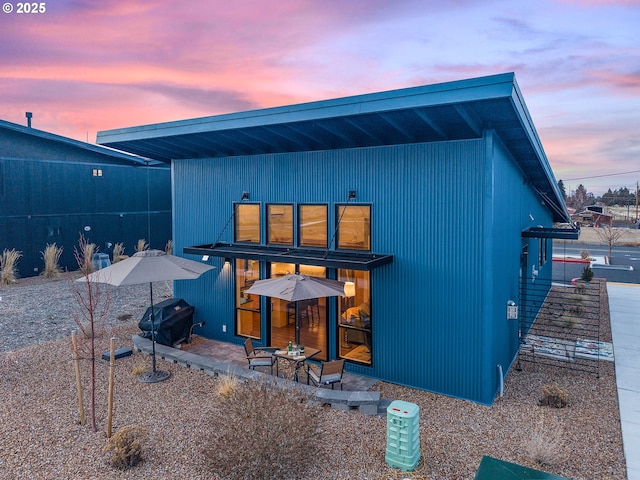 view of back house at dusk