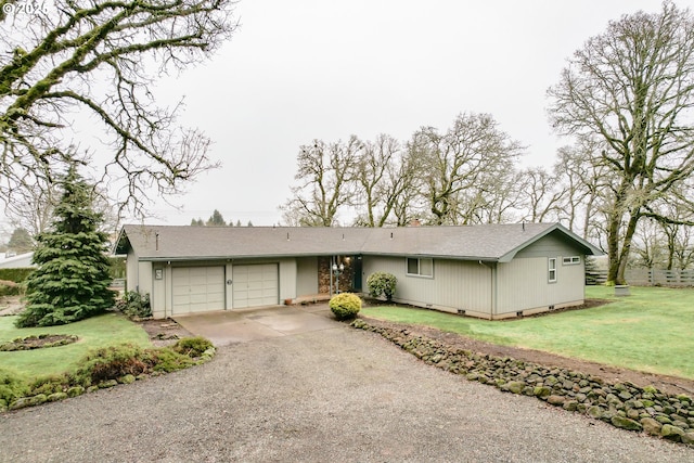 ranch-style house featuring a front lawn and a garage