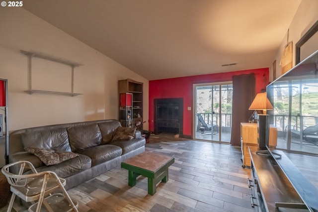 living room featuring hardwood / wood-style flooring and vaulted ceiling