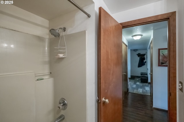 bathroom with hardwood / wood-style floors and shower / bathtub combination