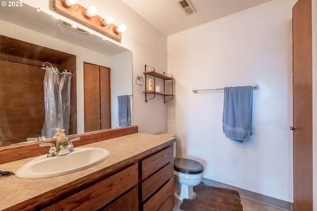 bathroom with a shower with curtain, tile patterned floors, vanity, and toilet