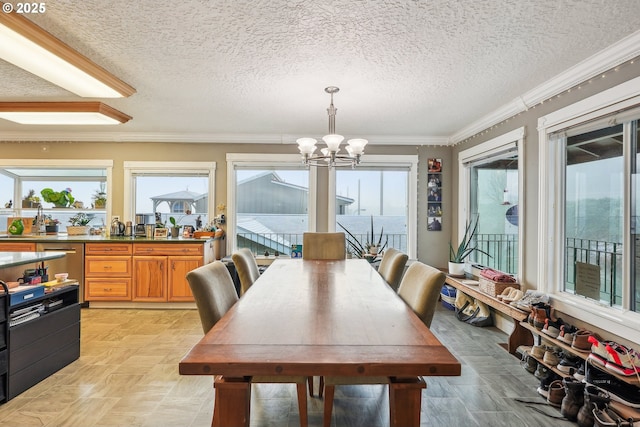 dining area featuring crown molding, a textured ceiling, and an inviting chandelier