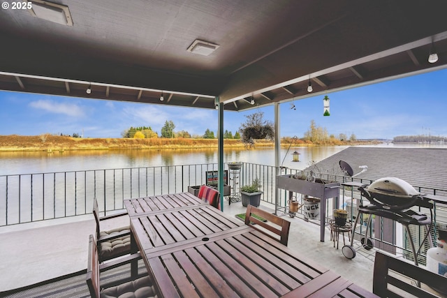 view of patio featuring a water view, a balcony, and a grill