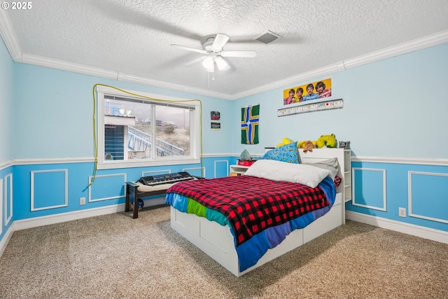 bedroom featuring crown molding, carpet floors, and a textured ceiling