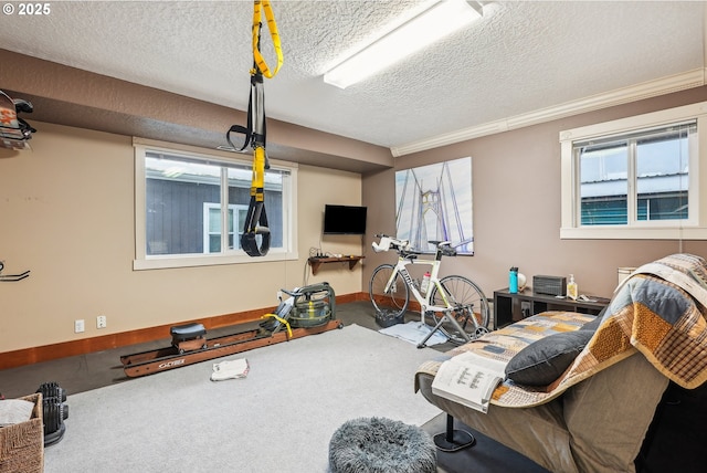 workout room with crown molding and a textured ceiling