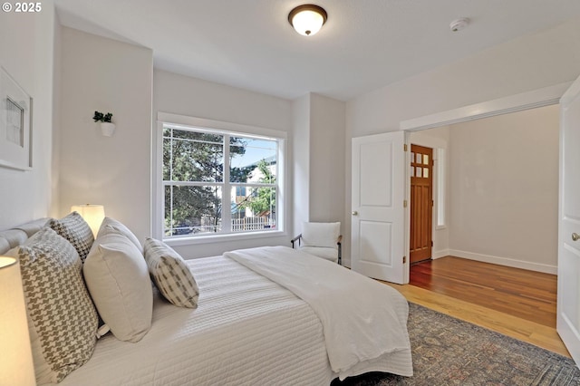 bedroom with hardwood / wood-style floors