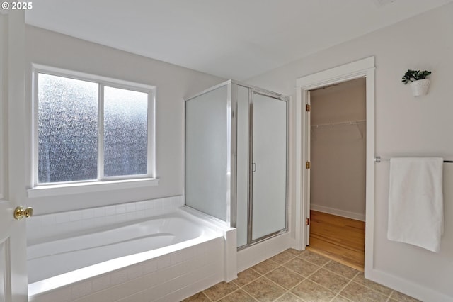 bathroom featuring tile patterned flooring and separate shower and tub