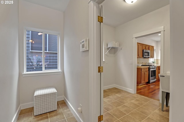 bathroom with vanity, backsplash, a wealth of natural light, and tile patterned floors