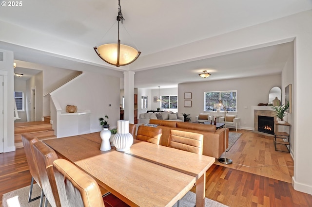 dining space featuring hardwood / wood-style flooring and a tile fireplace