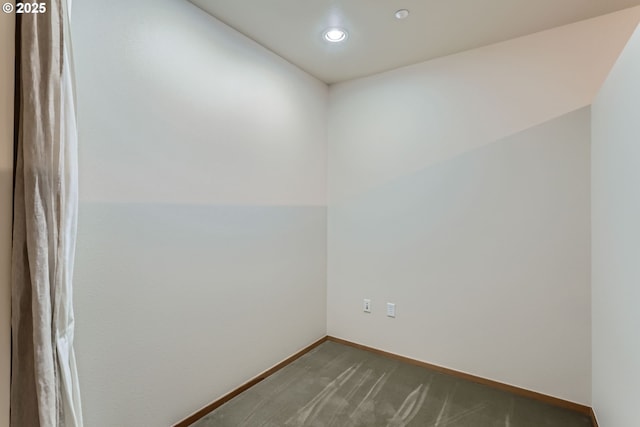 unfurnished room with baseboards, dark carpet, and recessed lighting