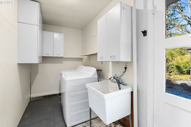 laundry area with separate washer and dryer, sink, and cabinets