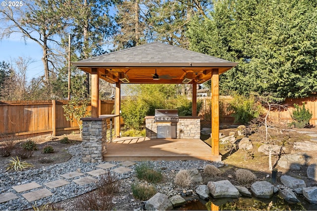 view of patio / terrace with a wooden deck, a grill, a gazebo, and an outdoor kitchen