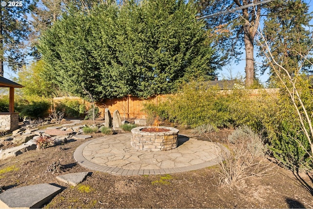 view of yard featuring an outdoor fire pit and a patio area