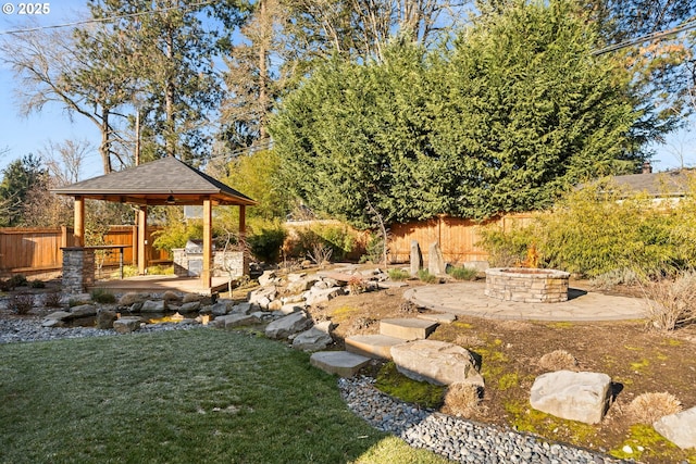 view of yard with a gazebo, a patio area, and an outdoor fire pit