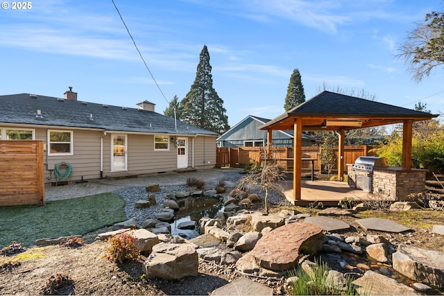 rear view of house featuring a gazebo, exterior kitchen, and a patio