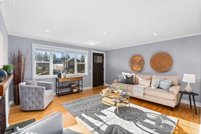 living room with crown molding and light hardwood / wood-style flooring