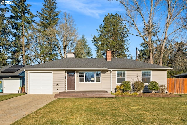 ranch-style home with a garage, a front yard, and solar panels