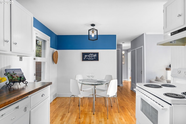 kitchen with wood counters, white appliances, light hardwood / wood-style floors, and white cabinets