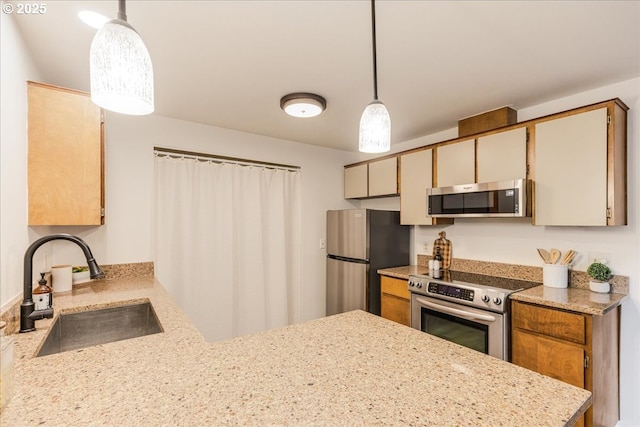 7148 SW Murray Blvd, Beaverton, OR 97008 - kitchen with appliances with stainless steel finishes, a sink, a peninsula, decorative light fixtures, and light stone counters