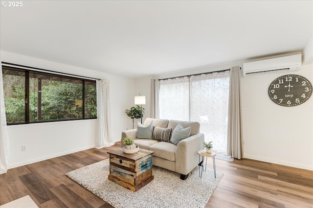 7148 SW Murray Blvd, Beaverton, OR 97008 - living area with an AC wall unit, healthy amount of natural light, wood finished floors, and baseboards
