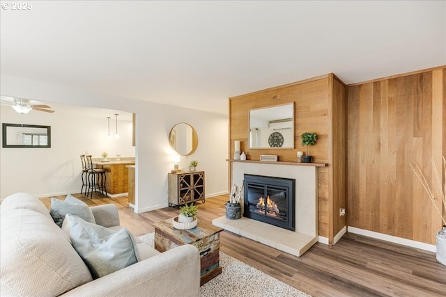 7148 SW Murray Blvd, Beaverton, OR 97008 - living room with a tile fireplace, wood finished floors, a ceiling fan, and baseboards