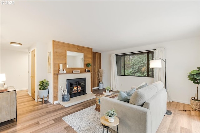 7148 SW Murray Blvd, Beaverton, OR 97008 - living area featuring a tile fireplace, light wood finished floors, and baseboards