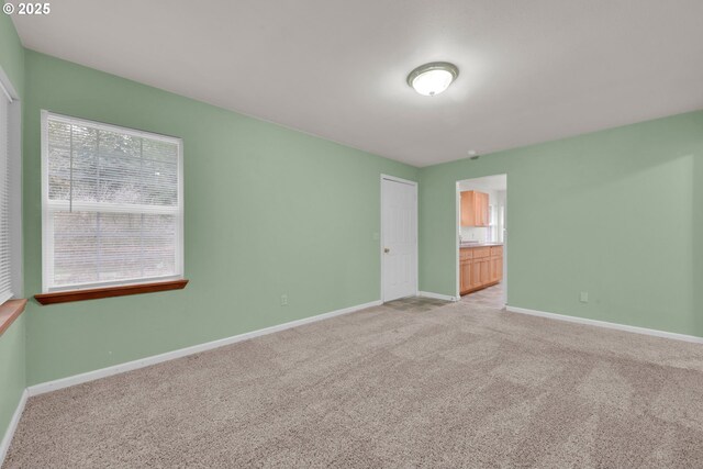 12813 Village Rd Unit 12, Swisshome, OR 97480 - empty room featuring baseboards and light carpet